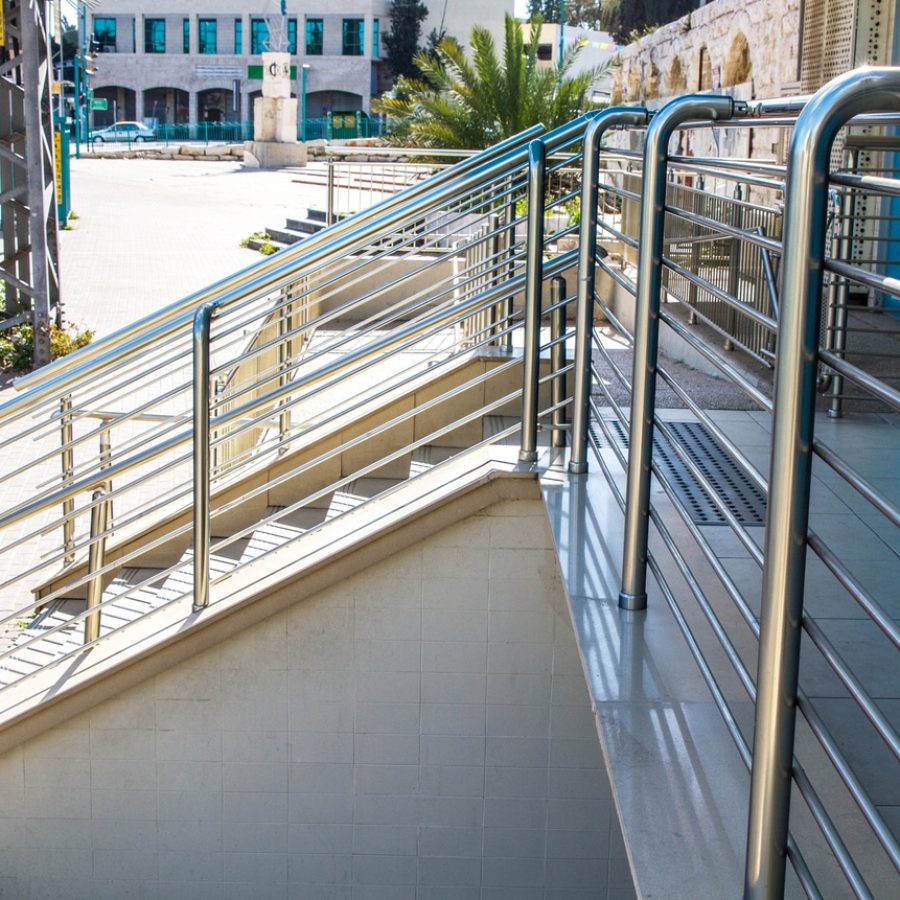 Stainless steel handrails are installed on the walls and steps.